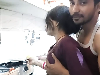 Old Indian fellow porks young Indian teenage in the kitchen